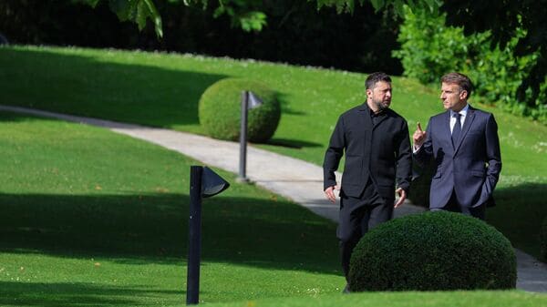 TOPSHOT - France's President Emmanuel Macron (R) greets Ukraine's President Volodymyr Zelensky ahead of the working session with G7 leaders and Ukraine during the G7 summit, in Evian, eastern France, on June 16, 2026. A G7 summit is set to take place June 15 to 17 in the French town of Evian-les-Bains near Switzerland and it will be attended by country leaders as well as the EU's foreign policy chief and ministers from Brazil, Canada, the United Arab Emirates and Turkey. (Photo by Ludovic MARIN / AFP)