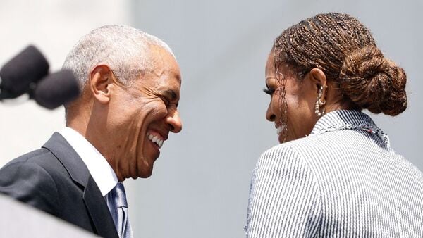 Former president Barack Obama and his wife Michelle Obama smile at each other during the opening of the Barack Obama Presidential Center in Chicago, Illinois, on June 18, 2026. (Photo by Kamil Krzaczynski / AFP)