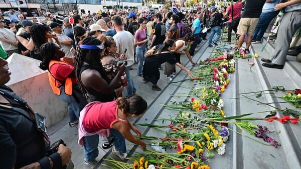 On June 18, 2025, on the eve of Juneteenth, the Black faith community and allies held a peaceful Interfaith Prayer Walk for Family Unity, marching through downtown Los Angeles to the Federal Building, where they laid flowers in tribute. (Photo by Frederic J. BROWN / AFP)