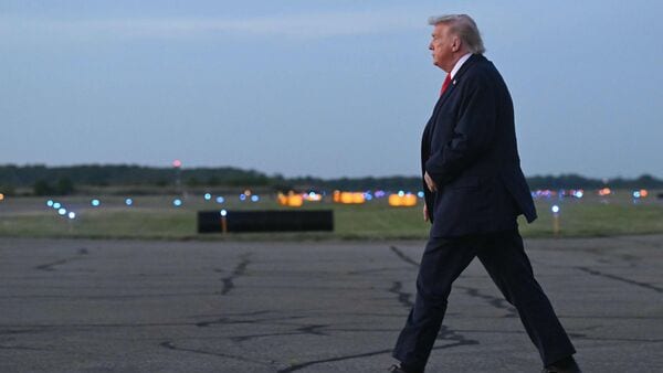 US President Donald Trump walks on the tarmac after disembarking Air Force One in New Jersey.