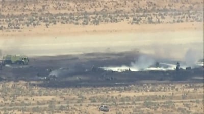 Smoke rises from a blackened part of Edwards Air Force Base after the crash of a U.S. Air Force B-52 bomber aircraft in Edwards, California, US, in a still image from news helicopter video. (ABC Affiliate KABC via REUTERS)