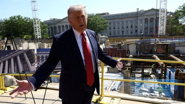 FILE PHOTO: U..S. President Donald Trump gestures at the site of ongoing construction of the planned White House ballroom in Washington, D.C., U.S., May 19, 2026. REUTERS/Kevin Lamarque