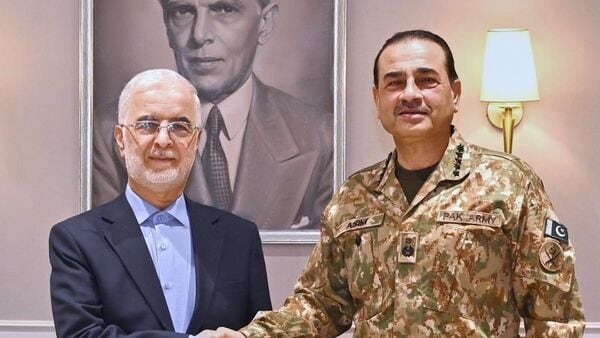 In this photo released by the Inter Services Public Relations, Iran's Interior Minister Eskandar Momeni, left, shakes hand with Pakistan's Army Chief Field Marshal Asim Munir prior to their meeting in Rawalpindi, Pakistan, Tuesday, July 21, 2026.