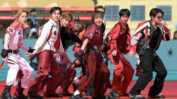 Members of the South Korean boy band BTS perform during the 2026 World Cup football tournament final match between Spain and Argentina at the New York/New Jersey Stadium in East Rutherford on July 19, 2026.  (Photo by JUAN MABROMATA / AFP)