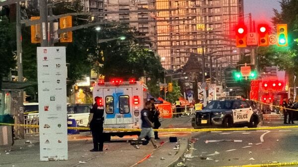 Police officers stand guard at the scene after a deadly shooting at a salsa-themed street festival in Toronto, Ontario, Canada, July 11, 2026.
