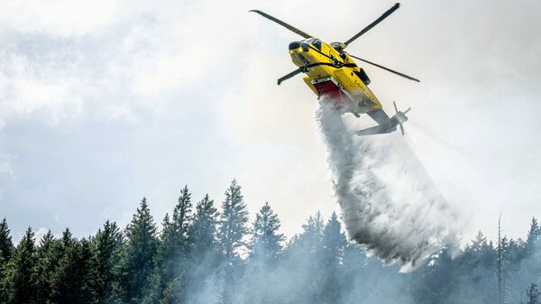 A helicopter drops water on the Brunswick Complex wildfires near North Bend, British Columbia, Canada July 11, 2026.  BC Wildfire Service/Handout via REUTERS.