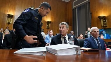 Attorney David Schertler, representing former director of the National Institute of Allergy and Infectious Diseases Anthony Fauci, is escorted out during a Senate Homeland Security and Governmental Affairs Committee hearing in Washington, DC, US, on Wednesday, July 29, 2026.  Photographer: Al Drago/Bloomberg