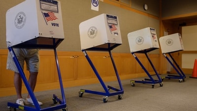 (FILES) A voter stands in a booth at a voting station at the Metropolitan Museum of Art (MET) during the mayoral election process in New York on June 12, 2021. (AFP)