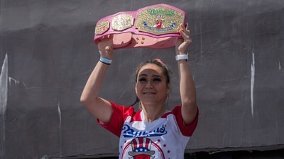 Competitive eater Miki Sudo raises a champion belt as she arrives at the 2025 Nathan's Famous Fourth of July hot dog eating contest in the Coney Island section of the Brooklyn borough of New York, Thursday, July 4, 2025. (AP Photo/Yuki Iwamura,File) (AP Photo/Yuki Iwamura)