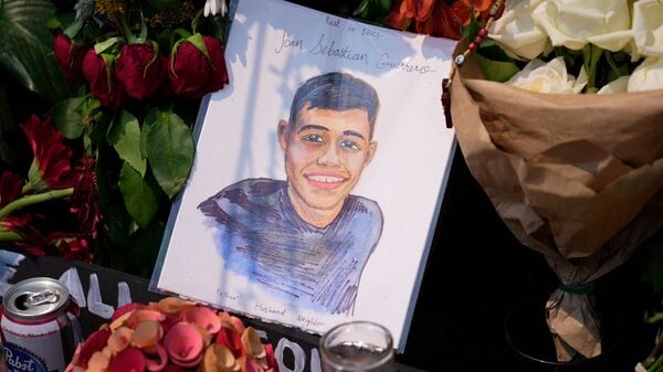 A portrait of Johan Sebastián Durán Guerrero, the man killed by U.S. Immigration and Customs Enforcement, is displayed among flowers and tributes at a makeshift memorial in Biddeford, Maine, Wednesday, July 15 2026. (AP Photo/Robert F. Bukaty)
