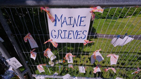 Notes of community support and sorrow are hung from a fence during a vigil for Johan Sebastian Duran Guerrero, a Colombian national who was shot and killed by an ICE agent, Friday, July 17, 2026, in Biddeford, Maine.