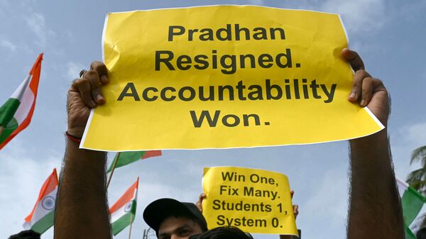 Protesters holding posters celebrate the resignation of India's Education Minister Dharmendra Pradhan in Mumbai on July 25, 2026 in solidarity with the ongoing nationwide protests over alleged NEET examination irregularities. India's Education Minister Dharmendra Pradhan resigned on Saturday after mass youth-led protests demanded his ouster in anger over a string of irregularities in potentially life-changing exams. (Photo by Indranil MUKHERJEE / AFP)