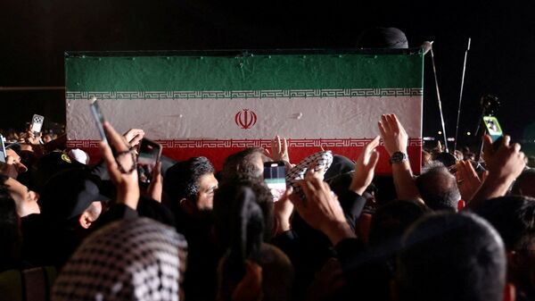 The casket of Iran’s late Supreme Leader Ayatollah Ali Khamenei, who was killed on February 28 during Israeli and U.S. airstrikes on Iran, is carried after arriving aboard a Mahan Air aircraft at Najaf International Airport in Najaf, Iraq, July 7, 2026.