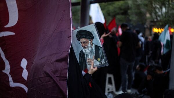 A mourner holds a portrait of Iran's late Supreme Leader Ayatollah Ali Khamenei, who was killed on February 28 in Israeli and U.S. airstrikes, during a funeral procession on the day of his burial, in Mashhad, Iran, July 9, 2026. REUTERS/Alkis Konstantinidis