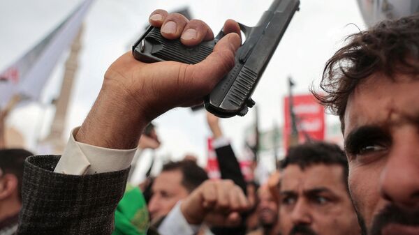 A Houthi supporter waves a pistol, during a rally against the Saudi-led coalition's restrictions on Houthi-controlled areas, which the group describes as a blockade, in Sanaa, Yemen, July 17, 2026. REUTERS/Khaled Abdullah     TPX IMAGES OF THE DAY