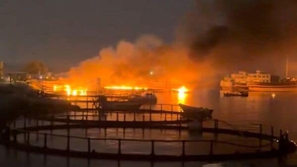 Smoke rises from a port, near Strait of Hormuz, following a US strike in Kuhestak, Iran