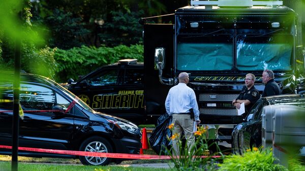 Michigan house fire: Law enforcement officials at the scene of a fatal house fire in Grand Haven Township on Friday, 24 July.