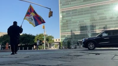 A man identified by Voice of Tibet, a media outlet of exiled Tibetans, as Tibetan activist Lobga Rangzen, walks carrying a Tibetan flag near the United Nations headquarters, before setting himself on fire in an appeal for Tibetan independence, in New York, U.S, July 2, 2026. ( Lobga Rangzen via REUTERS)