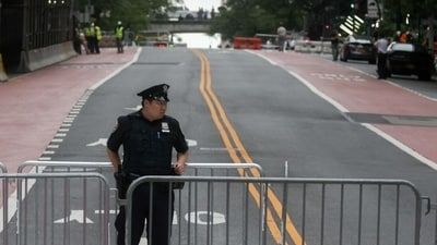 A New York Police Department (NYPD) officer near barricades blocking a street following reports of falling debris at 235 East 42nd Street. (Representational) (Bloomberg)