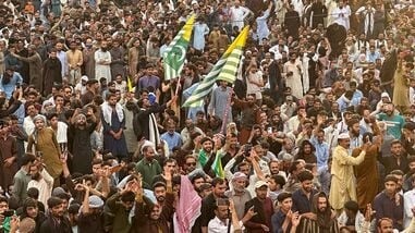 File image of the Supporters of the Joint Awami Action Committee (JAAC) gather as they shout slogans during a week-long protest in Rawalakot, in Pakistan-administered Kashmir, on June 24, 2026, following the group's ban under anti-terrorism laws by local authorities.