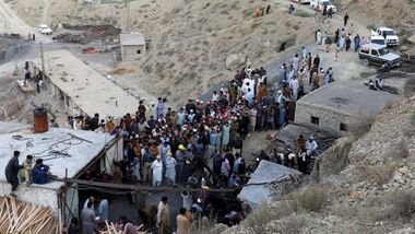 People gather after an explosion buried parts of a coal mining complex on the outskirts of Quetta, Pakistan, July 30, 2026.