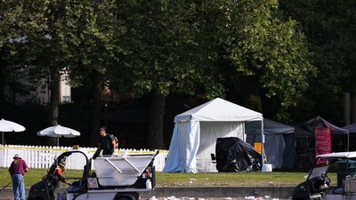 Workers clean up the day after a shooting at Seattle Center during the Bite of Seattle food festival in Seattle. (AP Photo/Lindsey Wasson)