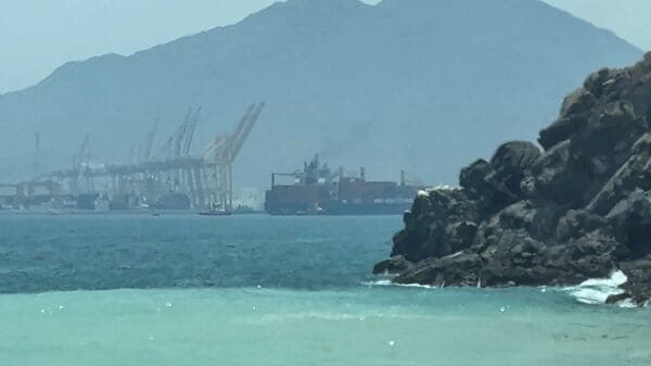 This frame grab taken from AFPTV video footage on July 12, 2026 shows a ship sailing near the Strait of Hormuz off the eastern coast of the United Arab Emirates at Khor Fakkan. (Photo by AFPTV / AFP)
