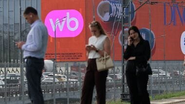 People wait for a train near a screen advertising the Wildberries online retailer in Moscow, Russia July 28, 2026.