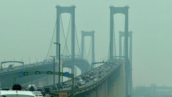 Cars travel across the Delaware Memorial Bridge as wildfire smoke from Canada causes hazy conditions, in New Castle, Delaware, on July 18, 2026. World Cup organizers said on July 17 that they were 'monitoring closely'the smoke gripping swaths of the United States ahead of the tournament's weekend final in New Jersey which has been affected by dangerously unhealthy air.