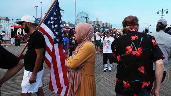People gather along the boardwalk at Coney Island before a fireworks show in Brooklyn on July 04, 2026, in New York City, which is currently under a heat dome,