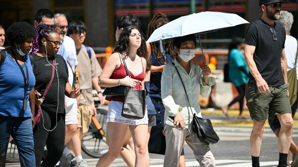 People cross a street in Midtown Manhattan during a heatwave in New York City on July 3, 2026. Blistering temperatures and humidity has gripped swaths of the United States this week, with more to come for the densely populated East Coast as the nation co-hosts the World Cup and prepares to celebrate its 250th birthday on July 4.