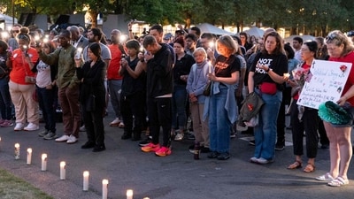 SEATTLE, WASHINGTON - JULY 27: People gather for a vigil a day after the Bite of Seattle food festival shooting at Seattle Center on July 27, 2026 in Seattle, Washington. (Photo by David Ryder / GETTY IMAGES NORTH AMERICA / Getty Images via AFP) (Getty Images via AFP)
