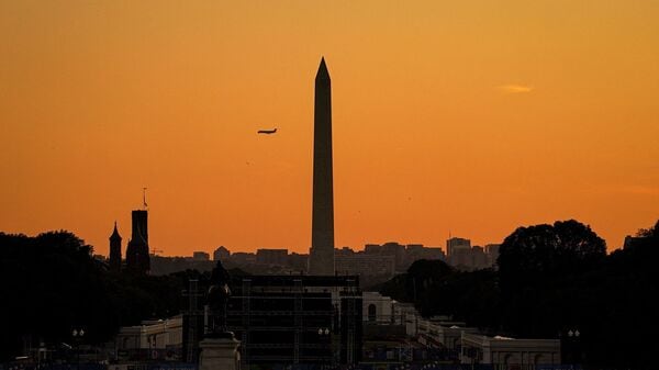 An American Eagle Mitsubishi CRJ-701ER plane passes behind the Washington Monument while approaching Ronald Reagan National Airport (DCA), following a vote on the Sunshine Protection Act, which would make daylight saving time permanent, and states with areas exempt from daylight saving time may choose the standard time for those areas, on Capitol Hill in Washington, D.C.
