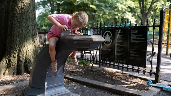 A girl drinks from a water fountain in Prospect Park amid a heatwave in New York City, U.S. July 1, 2026.