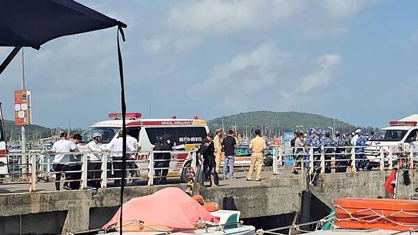 Ambulances line up on a pier to help victims of a boating accident after a tourist vessel capsized off Phu Quoc Island in southern Vietnam's An Giang Province on July 11, 2026. At least 15 people were killed when a tourist boat capsized off an island in Vietnam's south, state media reported on July 11. (Photo by AFP)