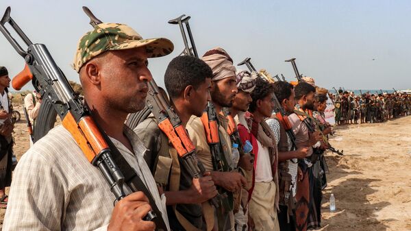 Fighters supporting the Aden-based internationally-recognised Yemeni government gather during a vigil along the Red Sea shore in Khokha, in Yemen's western Hodeidah province on July 20, 2026, calling for a resumption of hostilities with the Huthi group currently controlling the capital Sanaa. (Photo by Khaled ZIAD / AFP)