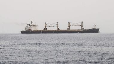 A commercial vessel passes through an international shipping lane off Yemen's Hanish Island in the Red Sea on July 27, 2026. (Photo by Khaled ZIAD / AFP) /