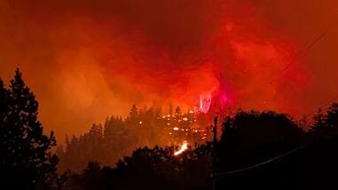 This handout photo, taken on August 7, 2026, and released on August 8 by the BC Wildlife Service, shows the Bald Range wildfire near Summerland in Canada's western British Columbia province. Canadian officials declared a state of emergency on August 8 after a fast-moving wildfire in the western province of British Columbia forced the overnight evacuation of more than 20,000 people, including some who were airlifted to safety.