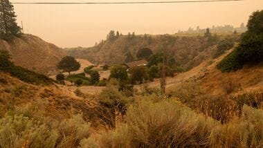Latest news on August 9, 2026: Smoke from the Bald Range wildfire covers Okanagan Lake, where many evacuees are being redirected to Penticton, British Columbia, Canada, August 8, 2026.