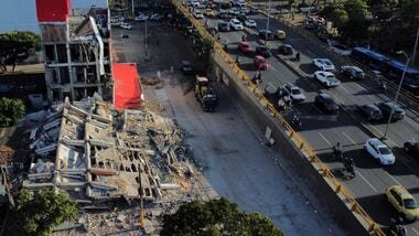 A drone view shows traffic passing a damaged building following an earthquake, in Cali, Colombia, August 11, 2026. REUTERS/Raquel Cunha 