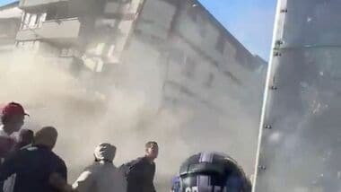 People watch as a building collapses during an earthquake in Pereira, Colombia August 10, 2026 in this screen grab obtained from a social media video. Social Media/via REUTERS