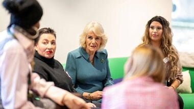 (FILES) Britain's Queen Camilla (C) talks with volunteers and visitors to the centre after officially opening 'Maggie's Royal Free', a new cancer support centre, at the Royal Free Hospital in east London on January 31, 2024. (Photo by Paul Grover / POOL / AFP)