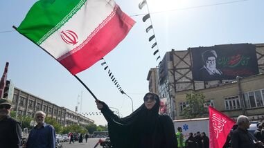 US-Iran War Live: A woman waves an Iranian flag as a banner showing a portrait of the late Supreme Leader Ayatollah Ali Khamenei is seen at rear during Arbaeen rituals. in Tehran, Iran,