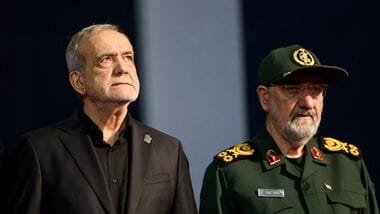 Iranian President Masoud Pezeshkian (L) and adviser to Iran's supreme leader Mohsen Rezaei (R)