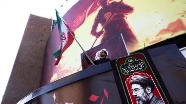 Latest news on August 18, 2026: A man holds an Iranian flag, next to a picture of Iran's Supreme Leader Mojtaba Khamenei, in Tehran, Iran, August 13, 2026. Majid Asgaripour/WANA (West Asia News Agency) via REUTERS