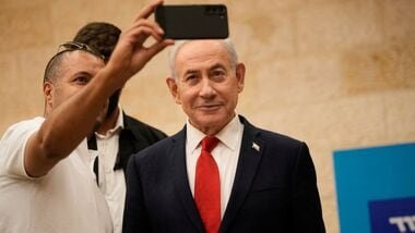 A man takes a selfie with Israeli Prime Minister Benjamin Netanyahu during Likud party primary elections ahead of Israel’s general election in October, in Jerusalem, Monday, August. 17, 2026.   Ohad Zwigenberg/Pool via REUTERS