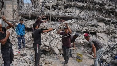 Palestinians remove iron from the rubble of buildings destroyed by Israeli airstrikes during the war with Hamas, repair and recycle it for construction, building tents or selling it, in Gaza City, Sunday, Aug. 16, 2026. (AP Photo/Jehad Alshrafi)