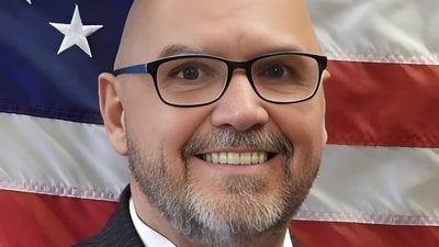 Mayor Ken Adams of Olive Branch, Mississippi, faced backlash after declining to lower the American flag for Dolly Parton, despite President Trump's directive. (Mayors-Office)