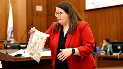 Prosecutor Jennifer Sprague of the Plymouth County DA's office enters a bag of prescription pills into evidence that were prescribed to Lindsay Clancy, who is accused of killing her children, during her murder trial at Plymouth Superior Court, in Plymouth, Massachusetts, U.S., July 27, 2026. Greg Derr/Pool via REUTERS (via REUTERS)