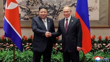 FILE PHOTO: North Korean leader Kim Jong Un shakes hands with Russian President Vladimir Putin
